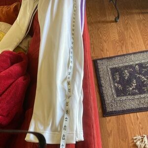 Adidas white purple stripes xl track pants in good condition loose fit. Zippers